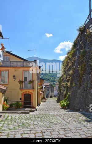 A narrow street between the old houses of Lagonegro, a medieval village in the mountains of southern Italy. Stock Photo