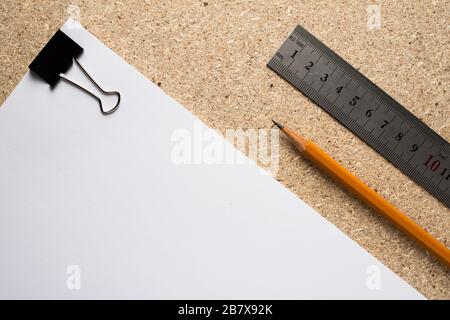Paper form, ruler and pencil on a chipboard table. Stock Photo