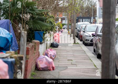 Uncollected recycling waste bags outside on the pavement, in the street, in Hainault Avenue, Westcliff on Sea, Essex, UK. Council services Stock Photo