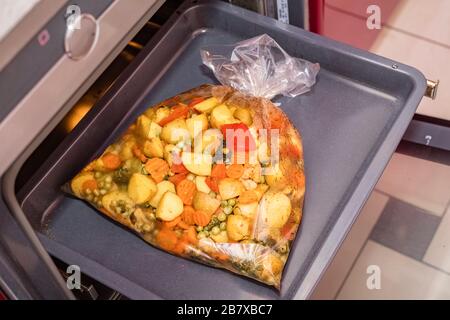 Baked vegetables in the oven baking bag. Cooking dishes. top view Stock Photo
