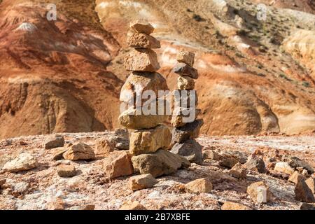 Balanced stone tower on the background of colorful mountains. Close up Stock Photo