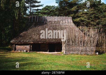 Estonian traditional vernacular architecture with straw thatched roof and log walls Stock Photo