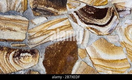 Seamless texture stone wall. Seamless background. Pattern of modern style design decorative uneven cracked real stone wall surface with cement. Fragme Stock Photo
