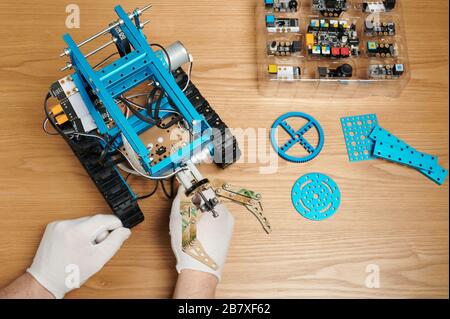 Learning robotics theme. Assembling robot kit educational program Stock Photo