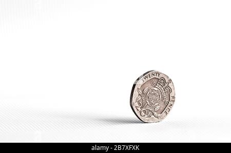 1996 Twenty pence piece coin balanced on side with tail side showing against a white background. Landscape with clear space on left side of image. Stock Photo