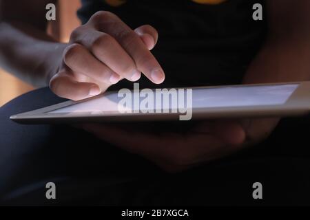 Close up of mans finger touching digital tablet screen Stock Photo