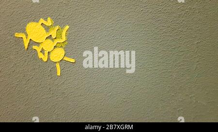 yellow painted ant on a gray wall. Ant climbing a wall. Colorful ants backgrounds. Local artists decorate the walls of the streets Stock Photo