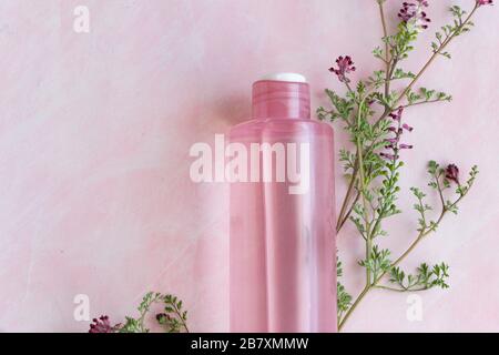 Hygiene bath product. Body, face lotion with wild flowers. Wellness therapy regeneration Stock Photo