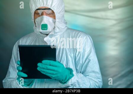 Epidemiologist using digital tablet computer in Wuhan coronavirus quarantine, conceptual image with selective focus Stock Photo