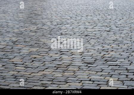 Ancient paving stones made of rectangular stone bricks. Textured background. Stock Photo