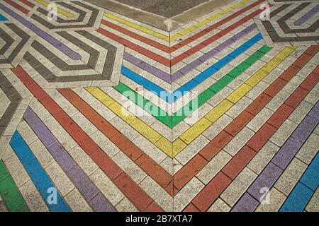 Close up view of colorful pavement stone walkway background. Colorful Stone pavement texture. Abstract background of cobblestone pavement. Stock Photo