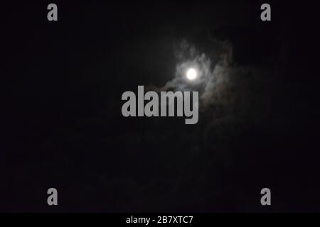 Beautiful night view of moon covered with cloudes Stock Photo