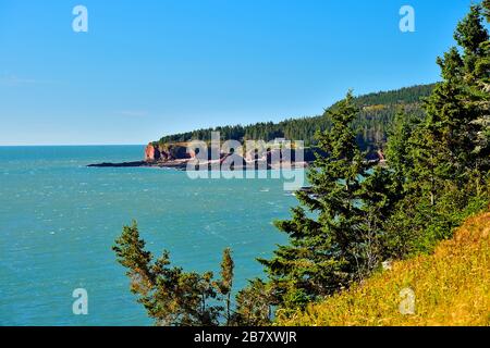 A landscape image of the Atlantic coast along the Bay of Fundy near Saint Martins New Brunswick Canada Stock Photo