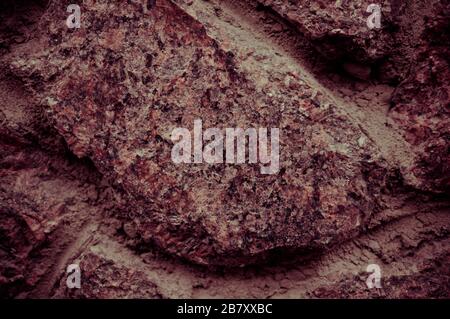 Texture of old stone wall closeup. Spectacular place for your inscription. Great design for any purpose. Photo toned in reddish tones with vignetting. Stock Photo