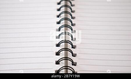 Close up top view of  lines notebook or spiral notepad paper background. Memo notebook paper. Stock Photo