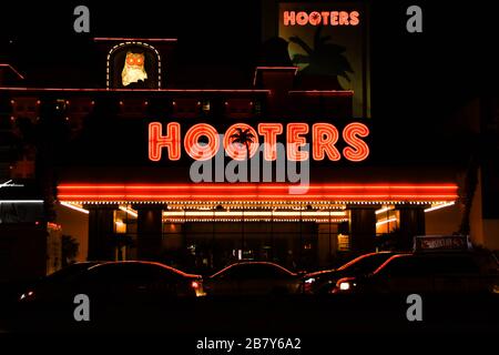 LAS VEGAS, NV, USA - FEBRUARY 2019: Signs and vehicles outside the Hooters Hotel in Las Vegas. Stock Photo