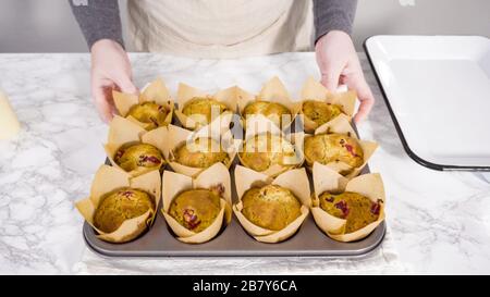 Step by step. Cooling freshly baked cranberry muffins. Stock Photo