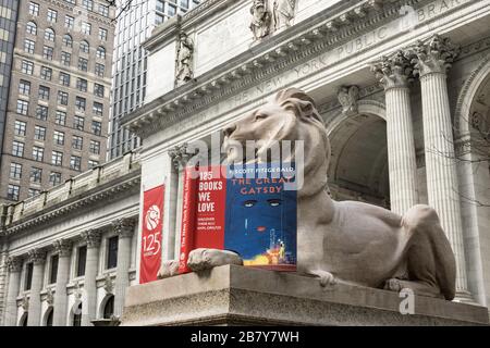Lion Statue with Book Celebrates 125 Years, New York Public Library, Main Branch, NYC Stock Photo