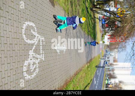 POZNAN, POLAND - Mar 08, 2020: Young small boy riding a running bike on a bicycle path in the city. Stock Photo