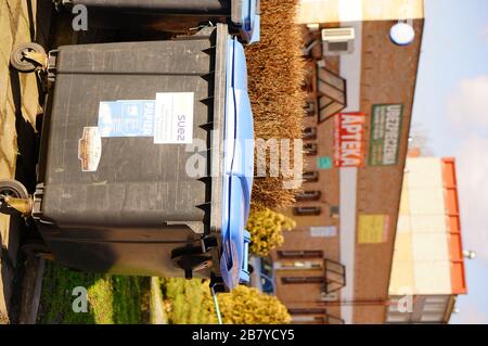 POZNAN, POLAND - Mar 08, 2020: Black plastic waste container by a street. Stock Photo