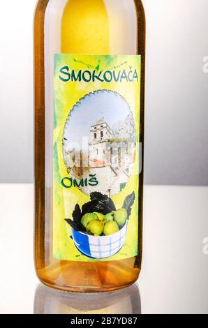 Bottle of fig flavored rakija isolated on gradient background produced in Omis,Croatia. Rakija is most commonly made out of grapes in Balkan countries Stock Photo