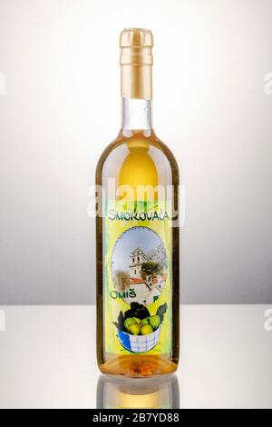 Bottle of fig flavored rakija isolated on gradient background produced in Omis,Croatia. Rakija is most commonly made out of grapes in Balkan countries Stock Photo