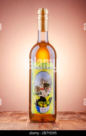 Bottle of fig flavored rakija isolated on gradient background produced in Omis,Croatia. Rakija is most commonly made out of grapes in Balkan countries Stock Photo