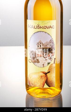 Bottle of pear flavored rakija isolated on gradient background produced in Omis,Croatia.Rakija is most commonly made out of grapes in Balkan countries Stock Photo