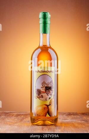 Bottle of pear flavored rakija isolated on gradient background produced in Omis,Croatia.Rakija is most commonly made out of grapes in Balkan countries Stock Photo