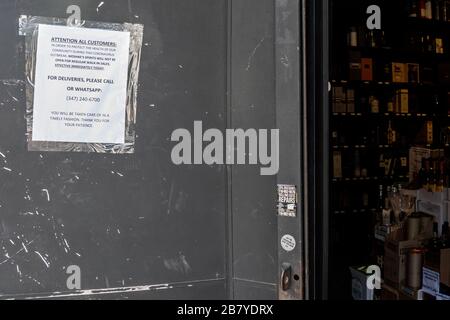 Brooklyn, USA . 18th Mar, 2020. A sign outside 'Moshke's Spirits' informs customers that it is not open for regular walk-ins on March 18, 2020, in the Borough Park neighborhood of Brooklyn. At least 100 people have tested positive for Coronavirus in the predominantly Hasidic community since Friday. (Photo by Gabriele Holtermann-Gorden/Sipa USA) Credit: Sipa USA/Alamy Live News Stock Photo