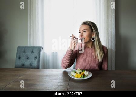 A Young and Beautiful Woman Maintaining Youth with Healthy Eating Stock Photo