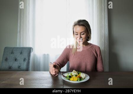 A Young and Beautiful Woman Maintaining Youth with Healthy Eating Stock Photo