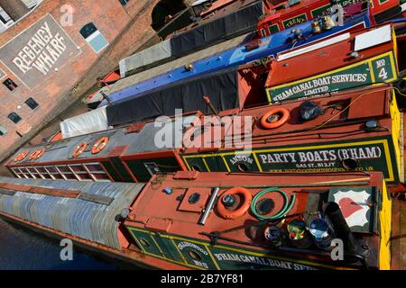 Many colourful canal boats are moored in Gas Street Basin on Birmingham Canal Old Line, Birmingham, West Midlands, UK Stock Photo