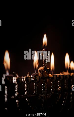 Lit candles in menorah Stock Photo