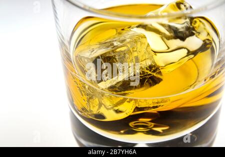 Glass of whiskey with ice cubes Stock Photo