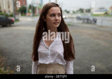 Young woman in parking lot Stock Photo