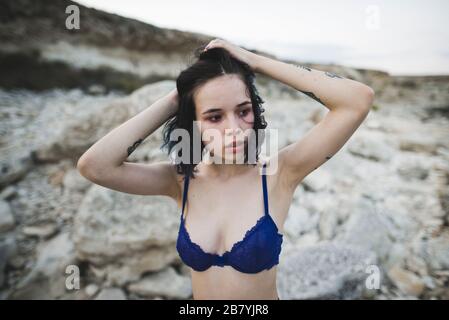 selective focus of woman with bra in hand and boyfriend lying on bed Stock  Photo - Alamy