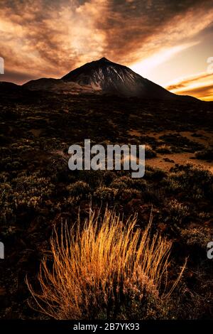 Sunset with beautiful sky and colors at the mountains with view on giant El teide vulcan top in Spain national park Stock Photo