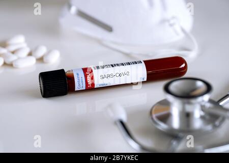 Testing for presence of coronavirus. Tube containing a blood sample for SARS-CoV-2 (COVID-19). Stock Photo