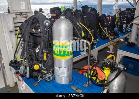 Scuba diving equipment and a nitrox cylinder on the back deck of the live-aboard vessel Infiniti in the Philippines. Stock Photo