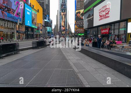 New York, NY - March 18, 2020: Times Square is sparsely populated due to ongoing coronavirus cases and fears Stock Photo
