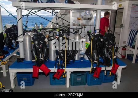 Scuba diving equipment and the filling station with nitrox cylinders on the back deck of the live-aboard vessel Infiniti in the Philippines. Stock Photo
