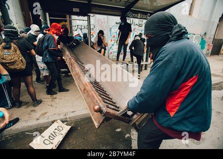 SANTIAGO, CHILE-NOVEMBER 8, 2019 - Protesters loot the church 'Parroquia de la Asuncion' to make barricades during the protests against the government Stock Photo