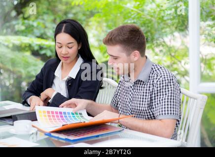 young business people making meeting and looking at document for analyzing marketing working at office on desk. Stock Photo
