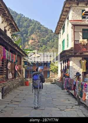 Woman hiking through villages in Ulleri Pokhara in Nepal Stock Photo