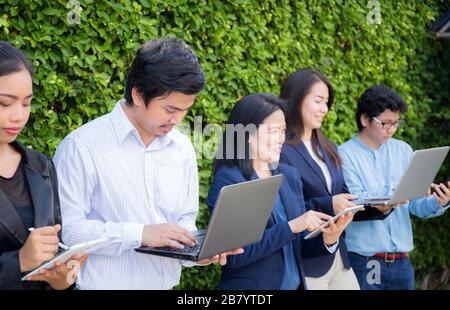 Business People Meeting Corporate Digital Device Connection Concept on tree wall. Stock Photo