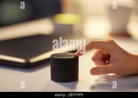 close up of hand with smart speaker at office Stock Photo