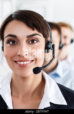 Three call center service operators at work Stock Photo