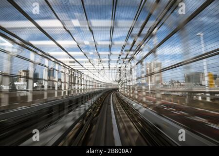 motion-blurred view from a moving train running in tunnel Stock Photo