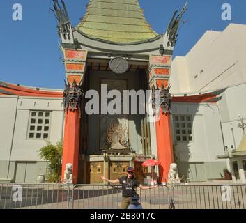Los Angeles, USA. 19th Mar, 2020. A woman poses behind barricades in front of a temporarily closed TCL Chinese Theater in Hollywood. The coronavirus pandemic has brought much of California to a standstill on Wednesday, March 18, 2020. The number of coronavirus cases in the Southland continues to rise and health officials say the illness will keep spreading. Photo by Jim Ruymen/UPI Credit: UPI/Alamy Live News Stock Photo